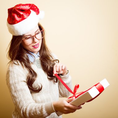 holding present box beautiful young lady in Christmas hat