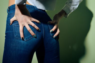 pretty female shape with hands on hips wearing jeans