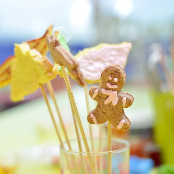 Closeup on gingerbread cookies on stick in glass — Stock Photo, Image