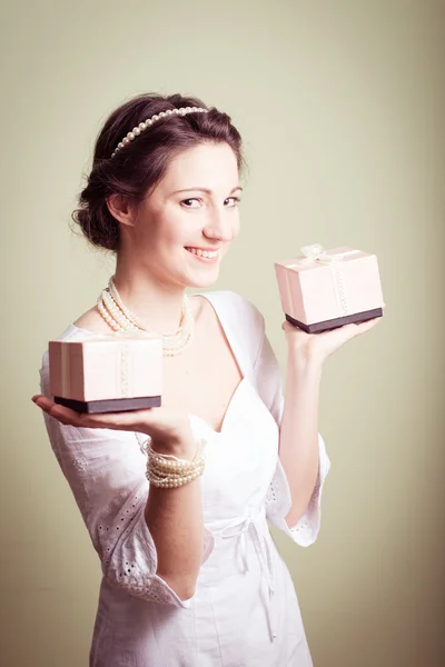 Holding present boxes up elegant beautiful young lady in white dress — Stock Photo, Image