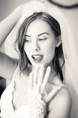 showing engagement ring and happy smiling beautiful sensual young lady