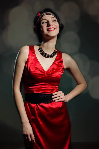 Pretty young lady in a stylish red dress — Stock Photo, Image