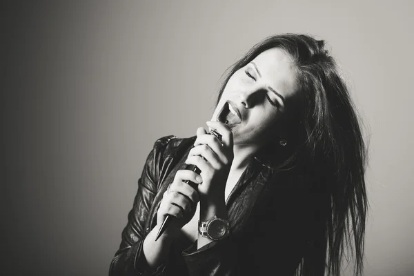 Portrait of pretty woman using hairbtush instead of microphone — Stock Photo, Image