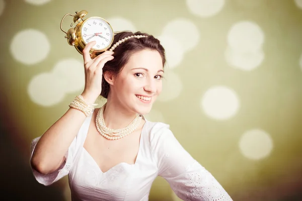 Young pretty lady holding an alarm clock on olive backgroundPortrait of man enjoying playing pipes in Ukrainian traditional shirt on green outdoors copy space summer field — Stock Photo, Image