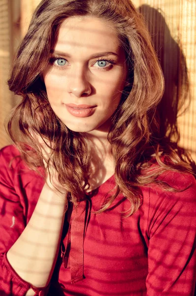 Beautiful young blue eyes lady with shadow from window blinds, closeup portrait — Stock Fotó