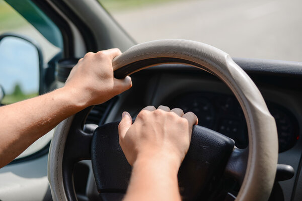 Руки, держащие колесо автомобиля и издающие звуки рога
