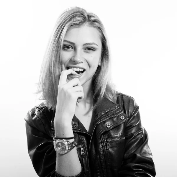 Black and white portrait of sexi young blonde lady in leather jacket posing happy smiling over light copy space background — Zdjęcie stockowe