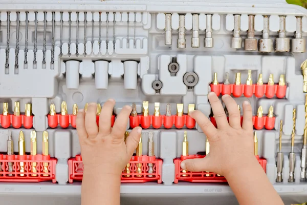 Young hands on drill bits. Closeup picture — Stock Fotó