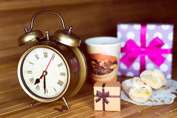 A coffee, two pastries, two present boxes and retro alarm clock — Stok fotoğraf