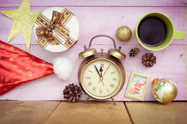 Closeup of coffee cup, alarm clock and christmas decorations on wooden background copy space — Stock Photo, Image