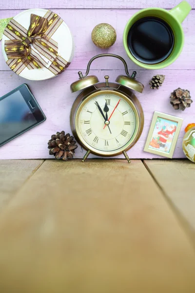 Picture of coffee cup, alarm clock and christmas decorations on wooden background copy space