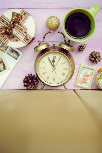 Closeup of coffee cup, alarm clock and christmas decorations on wooden background copy space — Stock Photo, Image