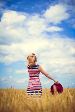 Image of one young pretty lady having fun standing in the field on blue sky background copy space 