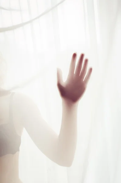 Close up on hand of sexy pretty lady having fun hiding in lingerie or bikini on window light copy space background — Zdjęcie stockowe