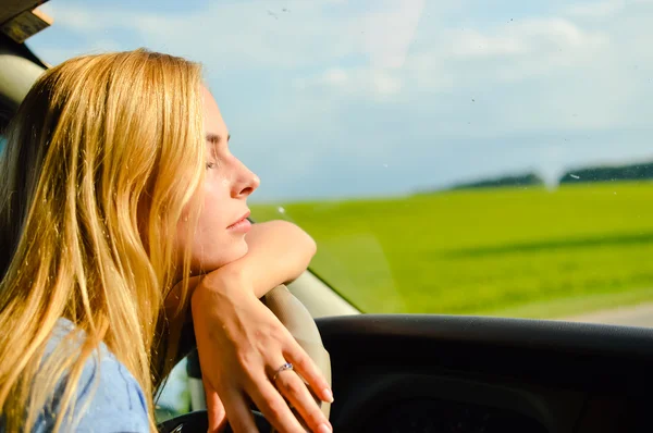 Half face closeup picture of young pretty lady waiting in car — Stock Photo, Image