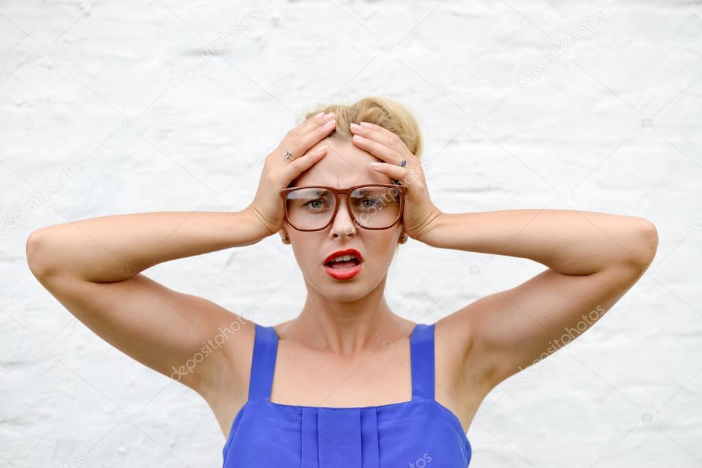 Picture of worried sad pin up lady in glasses taking her head in hands  