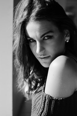 Beautiful young lady sensually looking at camera. Black and white closeup portrait