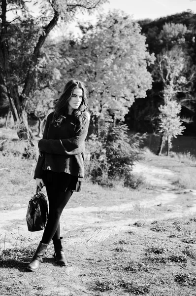 Picture of beautiful young lady with bag on outdoors background copy space