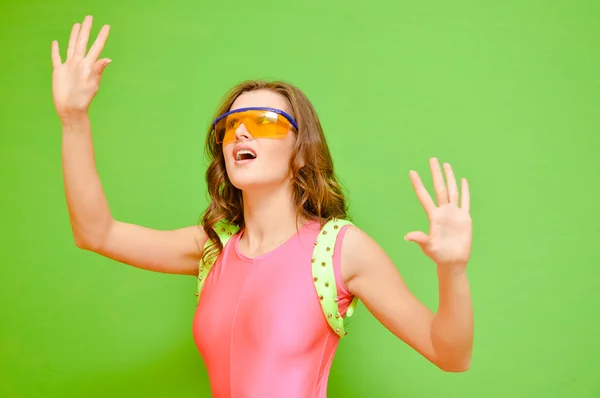 Woman wearing lycra jumpsuit and protect glasses on green background — Stock Photo, Image