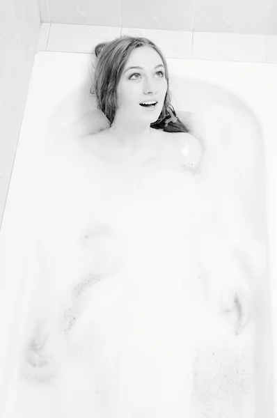 Picture of beautiful young woman relaxing in bath with foam having fun singing — Stok fotoğraf
