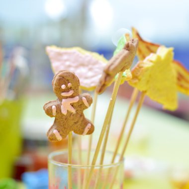 Picture closeup on gingerbread cookies on stick in glass