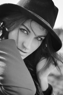 Elegant pretty young lady in jacket having fun joyfully looking at camera