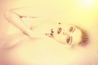 Beautiful tender young lady lying in the milk water. Black and white photography portrait