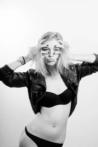 Making faces sexy beautiful young blonde woman in leather jacket and lingerie — ストック写真