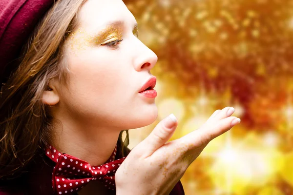 Closeup portrait of amazing girl in polka dot bow tie sending air kiss — Stockfoto