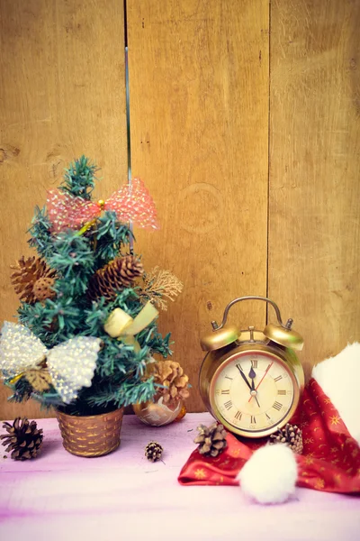 Artificial Christmas tree decorated with bows and vintage alarm clock — Stock Photo, Image