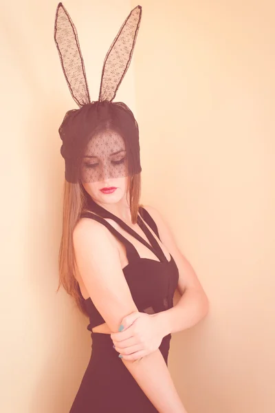 Picture of girl wearing black dress and lace bunny ears — Stock fotografie