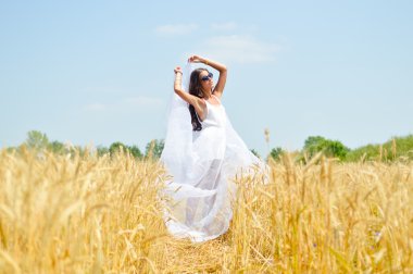 Image of joyful romantic beautiful young lady on wheat field, enjoying outdoors looking up on blue sky background copyspace
