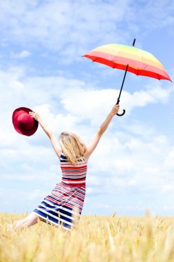 Colorful picture of elegant romantic female having fun holding up umbrella on blue sky copy space background