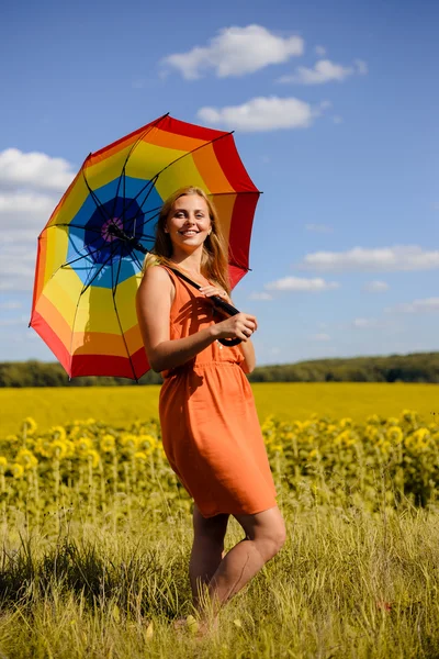 Beautiful young woman wearing dress with rainbow umbrella happy smiling — Stock Photo, Image
