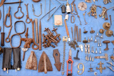 Metal aged rusty tools and different keys on blue background