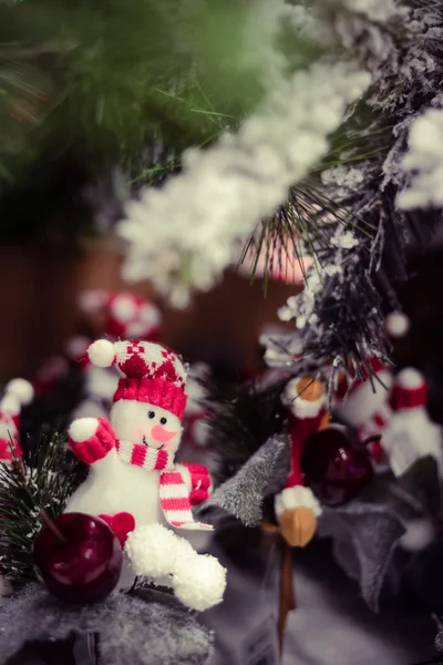 Beautiful little snowman ornament with red apples on christmas tree — 스톡 사진