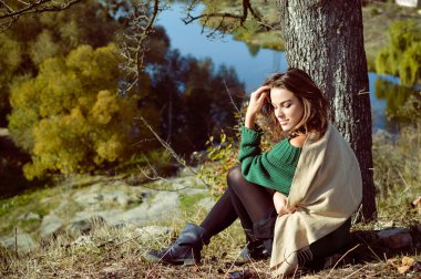 Female In Green Pullover Sitting Under The Tree