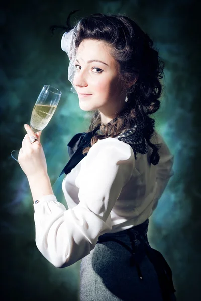 Picture of beautiful young lady with a glass of drink on light background — Stock Fotó