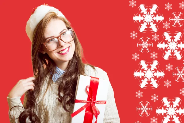 Picture of beautiful young lady in Santa red hat and glasses holding gift box — Stockfoto