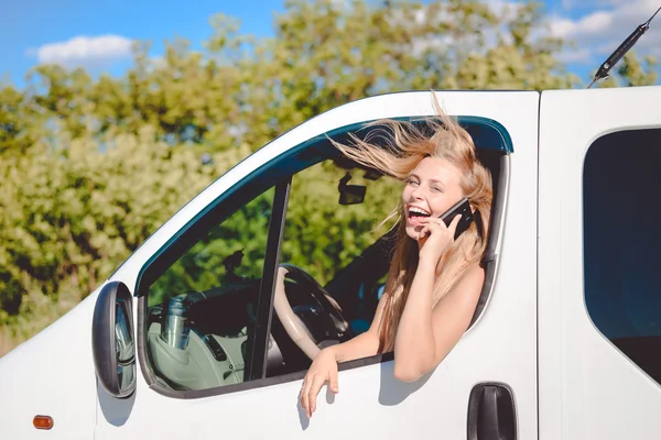 Emocionante rubia al volante hablando por teléfono — Foto de Stock