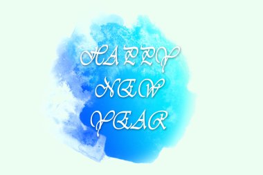 Happy New Year greetings writed on bright blue watercolor spot