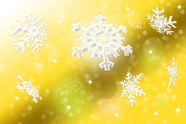 Weiße Schneeflocken auf verschwommenem gelben Hintergrund — Stockfoto
