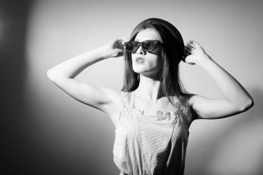 Black and white photography of exciting beautiful young lady in 3d glasses looking up.