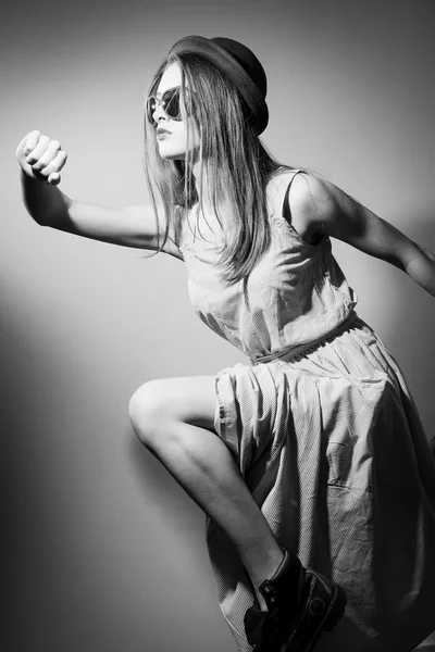 Black and white photography of running pretty girl with glasses in the shape of hearts and classy dress — Stockfoto