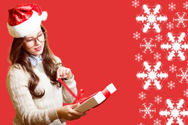 Happy romantic pretty woman in Santa red hat and glasses opening gift box on abstract festive background design