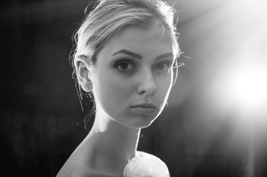 portrait of dreaming beautiful blond performer sexy tender girl having fun posing back side half naked standing on black light flare copy space background