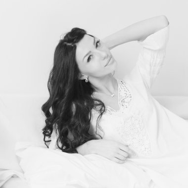 closeup on glamor brunette young pretty woman having fun happy relaxing lying in bed happy smiling