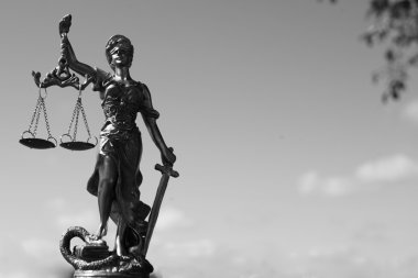 Image of sculpture of themis, femida or justice goddess on bright blue sky copy space background