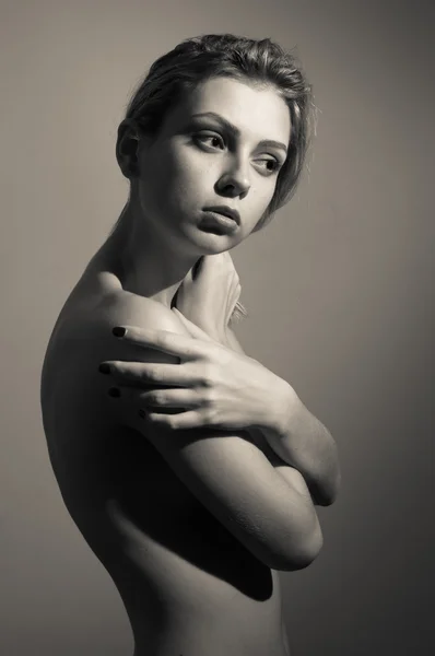 Portrait of beautiful sexy young lady looking aside covering her naked shoulder standing posing on copy space background — Zdjęcie stockowe