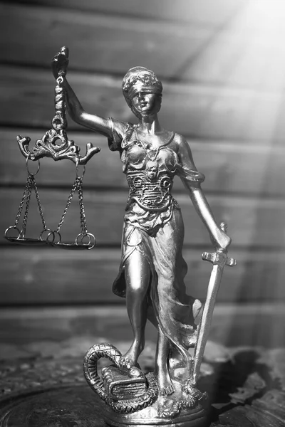 Sculpture of justice goddess on wood lining background — Stok fotoğraf